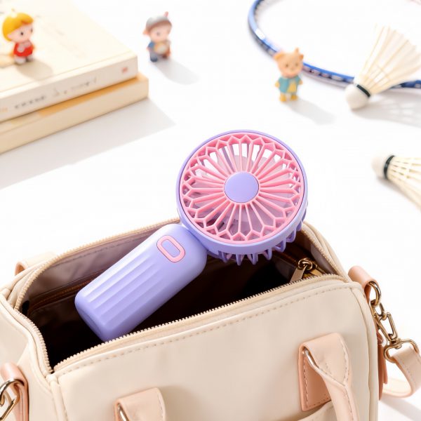 Purple rechargeable mini handheld fan stored in a handbag