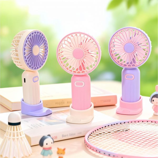 Off-white, pink and purple rechargeable mini handheld fans with desktop bases