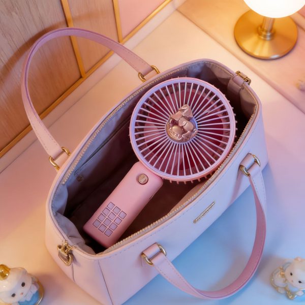 Purple portable mini handheld fan stored in a handbag