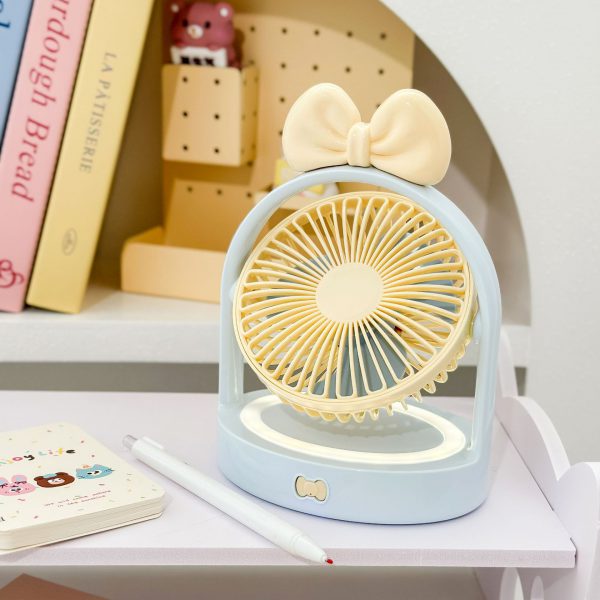 Blue Big Bow desktop fan on a desk with its illuminated base ring