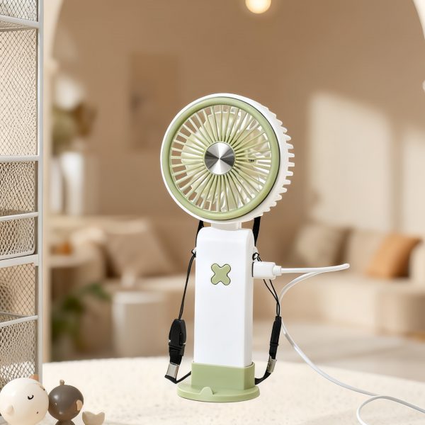 Green rechargeable fan standing on its base with a cable connected to its side