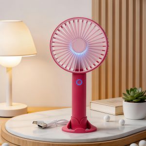 Red rechargeable handheld fan with desktop base, light and USB cable